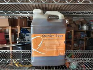 lot 12 image: 2-12 Gallons Of Quincy Air Compressor Fluid