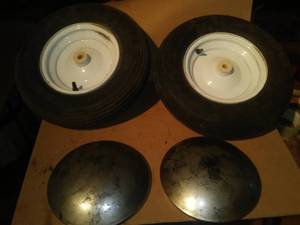 lot 296 image: (2) 8  wheels, tires - NEW  & moon hubcaps.