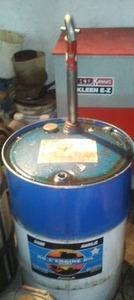 lot 290 image: 30 gal. Oil drum and pump - 5 gallons remain