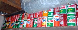 lot 506 image: 44 ft. of Vintage Beverage cans. No contents. Coke, Pepsi, Mt. Dew.