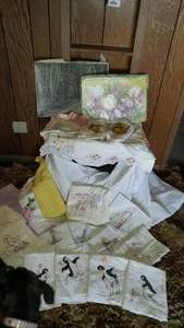 lot 528 image: Flour Sac Dish towels, Embroidered pieces, Aprons and more.
