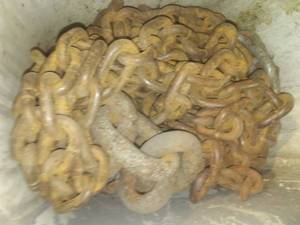 lot 345 image: Misc. sickle sections, teeth, chain. Wood pulleys.