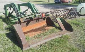 lot 130 image: John Deere 48  front end loader with snow extension and platform attachment.