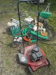 lot 386 image: Yard & garden hose, dcor, planter mower, fertilizer spreader.