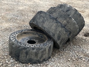 lot 7-A image: Set Of (4) Never-Flat Skid Loader Wheels & Tires