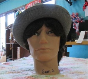 lot 103 image: Male mannequin head with hat...