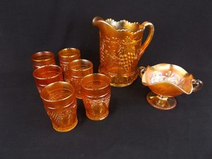 lot 46 image: Vintage Orange and Yellow 8 Piece Carnival Glass Pitcher Set