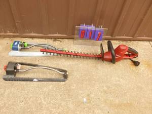 lot 17 image: Craftsman 110 volt hedge trimmer with qty of 2 lawn sprinklers. Appears near new. As shown.