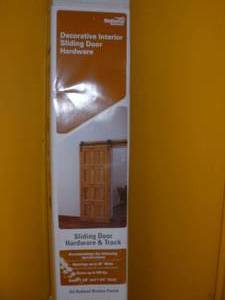 lot 12 image: National Hardware 72-in Bronze Interior Top Mount Barn Door Kit Retails $159  Missing a couple small pcs.