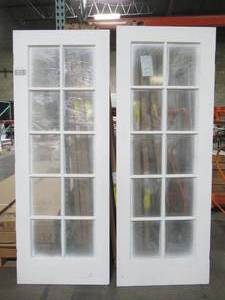 lot 611 image: Krosswood Doors, French Doors, Each Slab is a 30 in. x 80 in. 10-Lite Solid Hybrid Core MDF Primed Interior Door Slab - Some Slight ChipsScratches