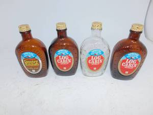 lot 102 image: Vintage Log Cabin Special Bicentennial Syrup Flasks