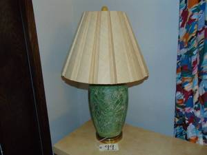 lot 99 image: Vintage green enameled lamp in Flower and leaf pattern with a brass lid and mounted on a brass base.