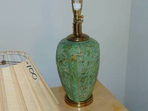 lot 100 image: Vintage green enameled lamp in Flower and leaf pattern with a brass lid and mounted on a brass base.