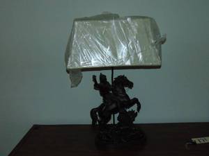 lot 171 image: Metal horse and rider lamp, comes with white shade (new) and black fabric shade 31 x 19