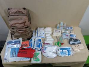 lot 82 image: Desert Camo Military Backpack with Medical Supplies