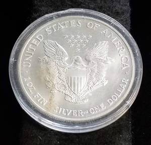 lot 38 image: 2002 AMERICAN SILVER EAGLE 1 TROY OZ. .999 FINE SILVER IN AIRTITE COLOR ENHANCED