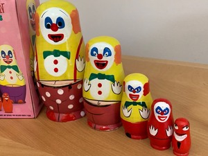 lot 220 image: Evil Clown Nesting Dolls and Push Up Robot Figurine