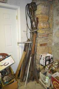 lot 219 image: Post Pounder, Steel Shafts, Belts, AC Manifold and More in Corner