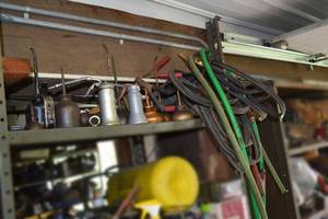 lot 274 image: Shelf of Old Oil Cans and Bunch of Jumper Cables