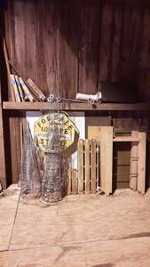 lot 202 image: Large Lot of Tomato Cages, Metal Sign, Wood and More Along Wall