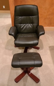 lot 31 image: Black Faux Leather Reclining Chair And Ottoman
