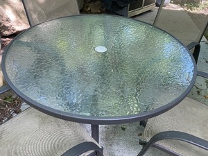 lot 24 image: Round Glass Top Patio Table with Chairs