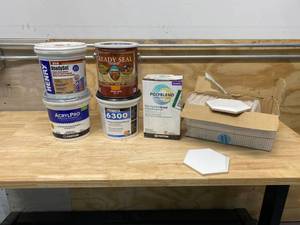 Lot of various home emprovement items.  Ceramic wall tile, Readyset premixed mastic adhesive, Pro Tile Adhesive, Pressure Sensitive Adhesive, Non-Sanded Grout, Exterior Wood Stain