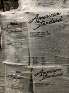 Pallet with 4 American Std Toilets open box customer returns one unit used