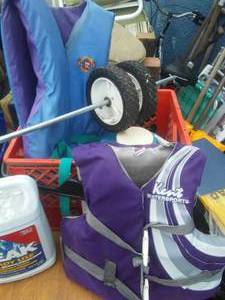 lot 116 image: Lifejackets, dairy crate, 1 gallon Peak antifreeze opened but Full, tires and more.