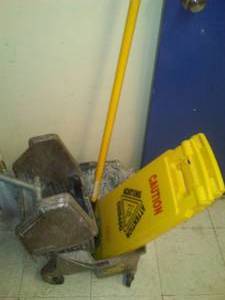 lot 510 image: Rubbermaid Wet Floor Sign (2) and Roller Scrub Bucket Set up