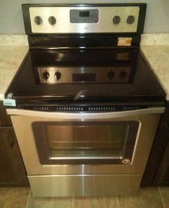 lot 136 image: New Whirlpool Stainless Smooth Top Electric Range.
