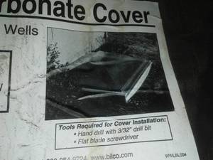 lot 690 image: Clear Poly Carbonate Cover. Egress window well cover. $400 retail