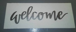 Welcome Sign, metal on Rough cut wood.