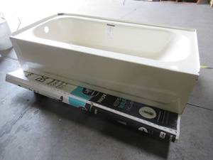 lot 337 image: Bootzcast 60 in. Left Drain Rectangular Alcove Soaking Bathtub in Bone, 011-7101-06. Slight Enamel Damage Close to Tile Flange.