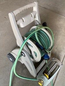 lot 100 image: Garden Hose Reel, Hose and Sprinkler