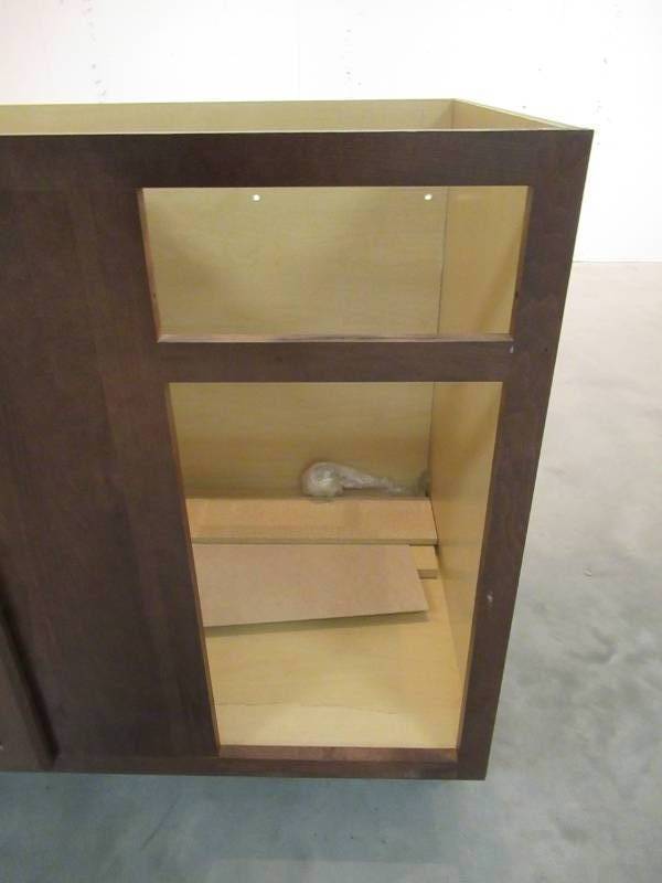 lot 6 image: Hampton Bay Assembled 36x34.5x24 in. Sink Base Kitchen Cabinet in Cognac KSB36-COG