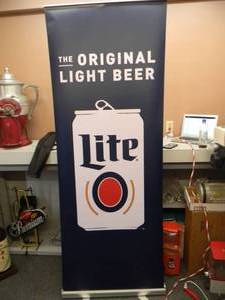 lot 18 image: MILLER LITE - Retractable display banner stand  easy to set up and take down OR CAN BE HUNG - LARGE  APPROX 30 X 80 - SEE PICTURES