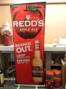 lot 37 image: REDDS - Retractable display banner stand  easy to set up and take down OR CAN BE HUNG - LARGE VERY COOL APPROX 30 X 80 - SEE PICTURES