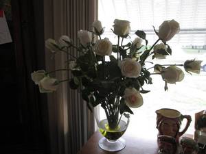 Vase with artificial white roses...