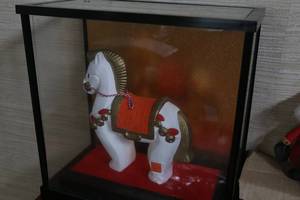 Ceramic horse in glass enclosure