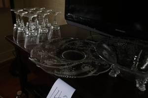 Lot of serving glassware and TV stand