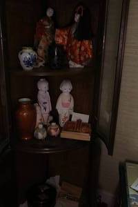 Shelf of Japanese dolls and decorative figures
