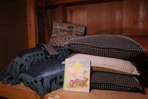 Lot of pillows and baby Jesus book...