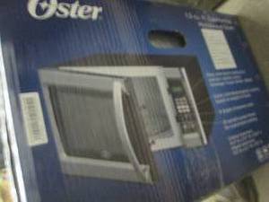 lot 1 image: Oster 1.3 cu ft 1100 Watt Microwave...