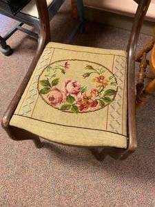 Tapersary chair with carving on the top