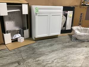 LOT WITH ASSORTED CABINETMOEN SINK & MARBLE VANITY TOP CUSTOMER RETURNS SEE PICS