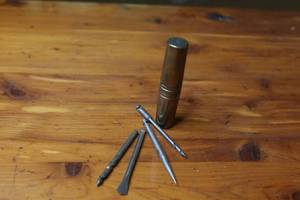 lot 42 image: Four antique drill bits and metal German carrying case