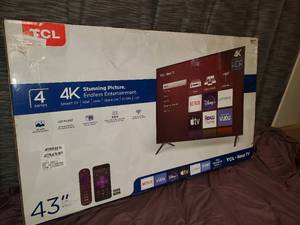 lot 25 image: TCL 4K Smart TV 43 with legs and remote