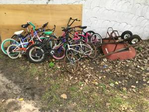 Lot of kid bikes and wheel barrows