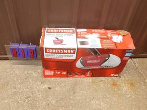 lot 12 image: Craftsman 12hp chain drive garage door opener. Smart tech adaptable. Appears new in box. As shown.